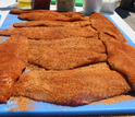 catfish fillets on a table ready to be cooked